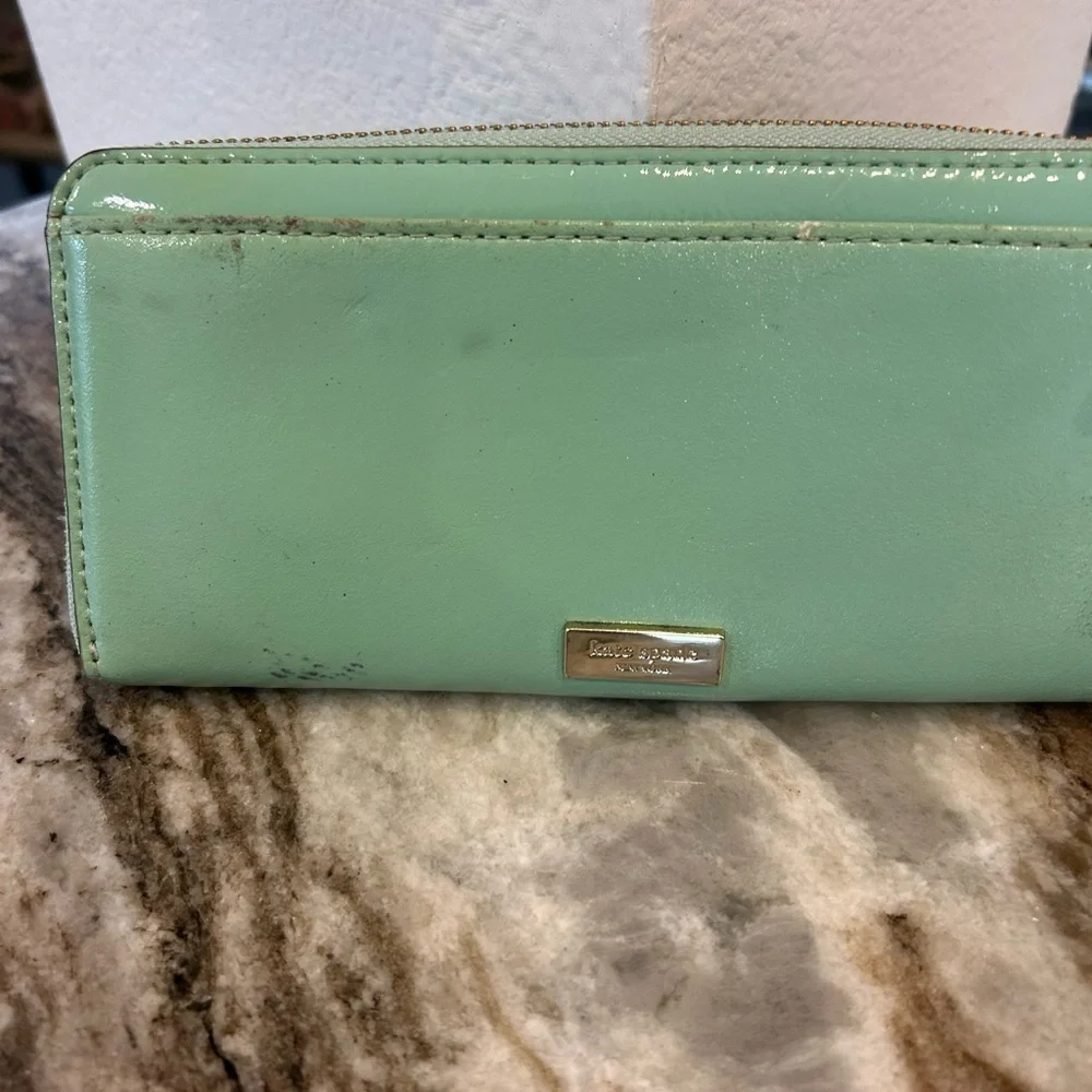 Kate Spade Chelsea park mint Wallet with Bow Accents has wear stains